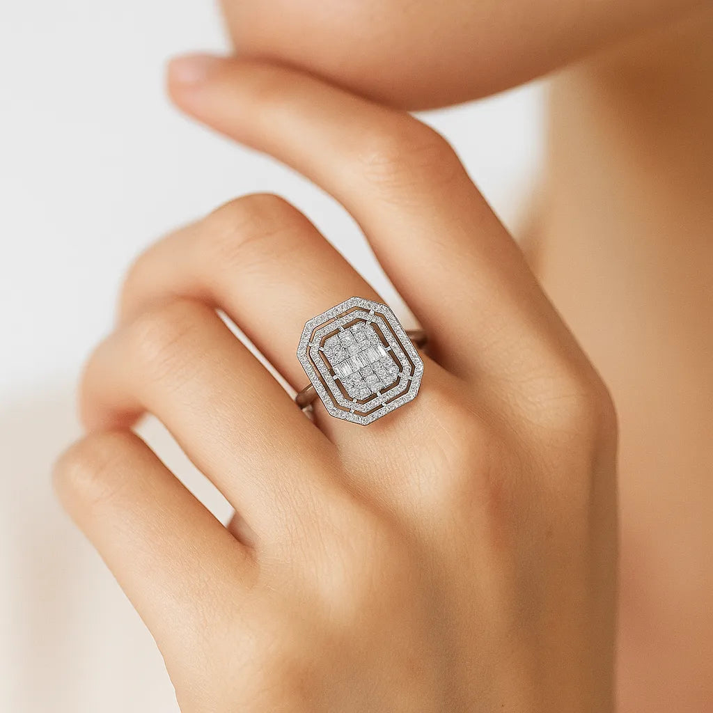Silver ring with gemstones on a hand against a neutral background