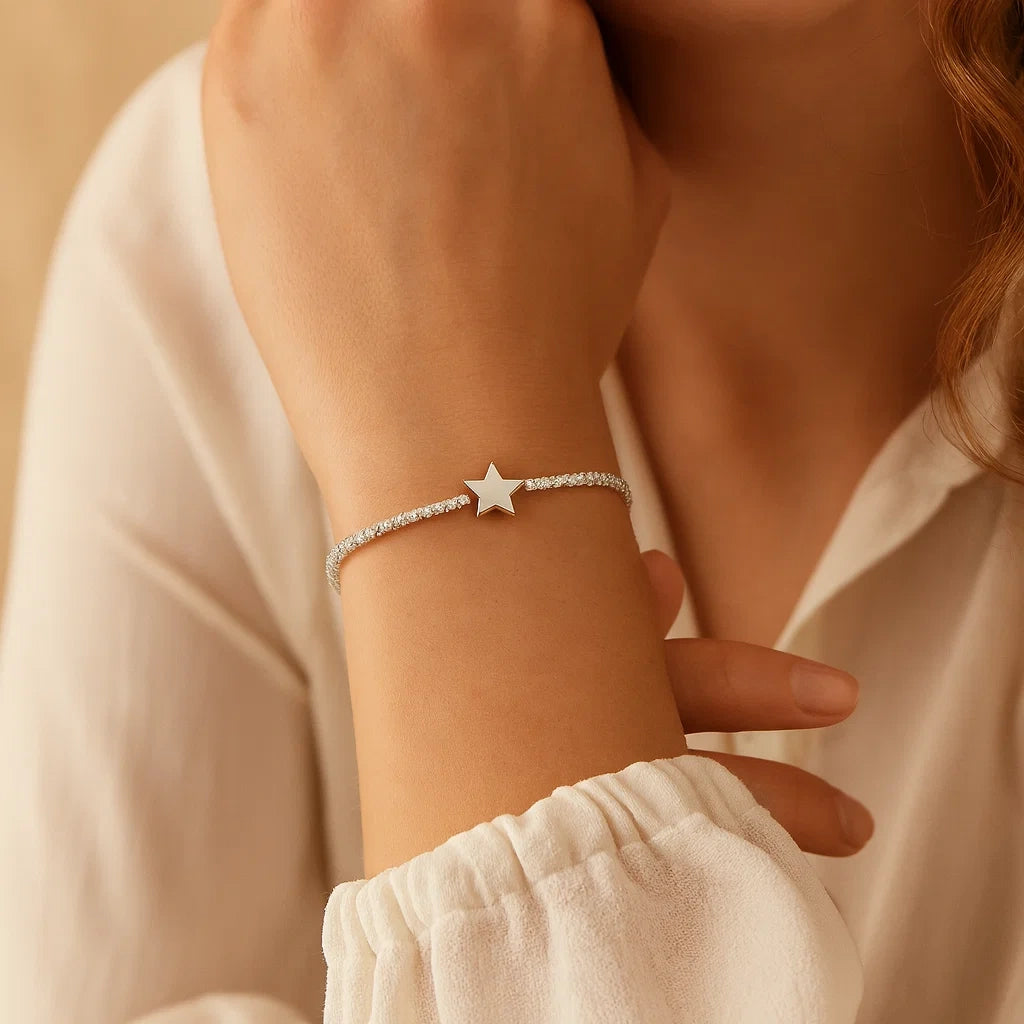 Star-shaped bracelet on a person's wrist with a neutral background