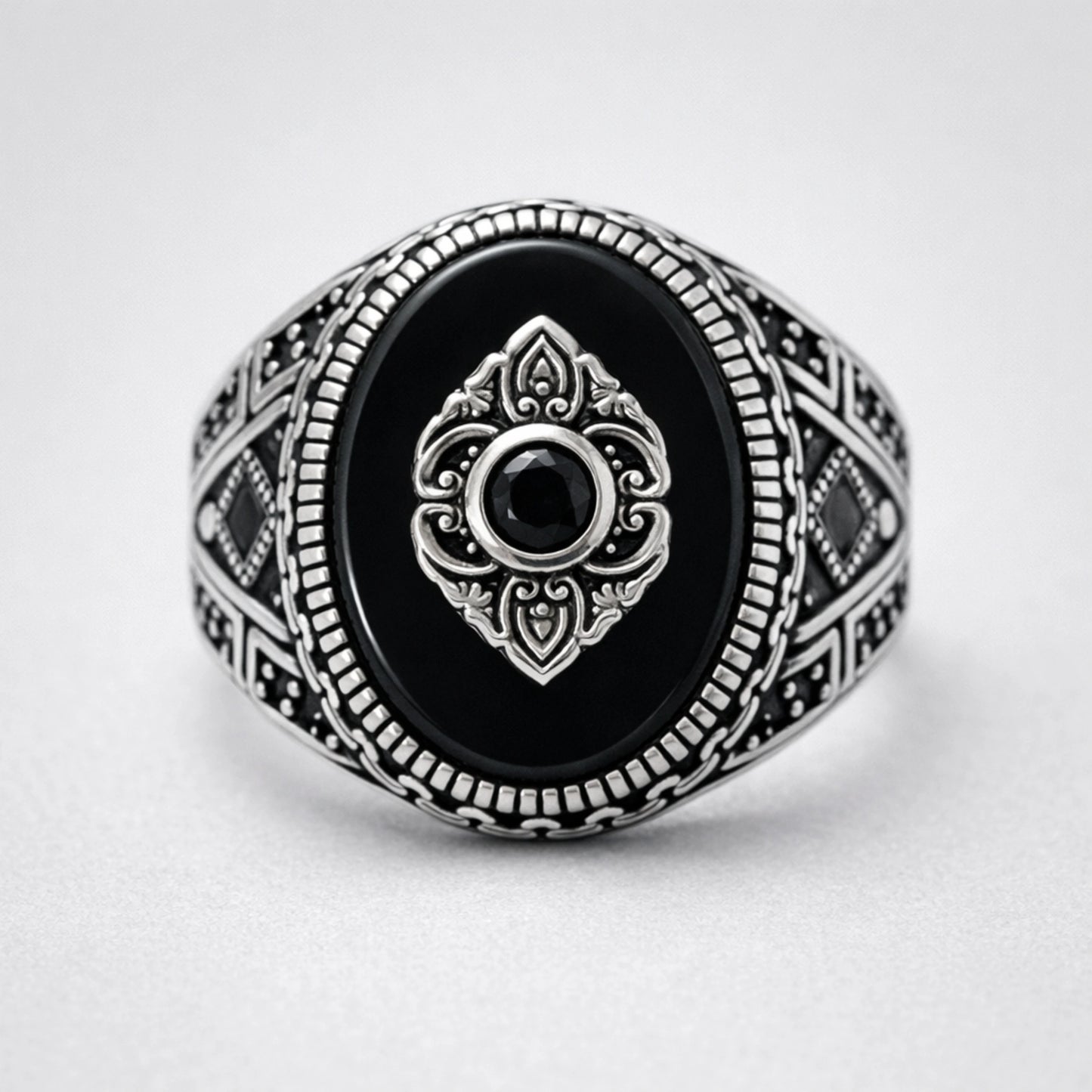 Men’s 925 sterling silver oval ring with glossy black stone and raised crest emblem