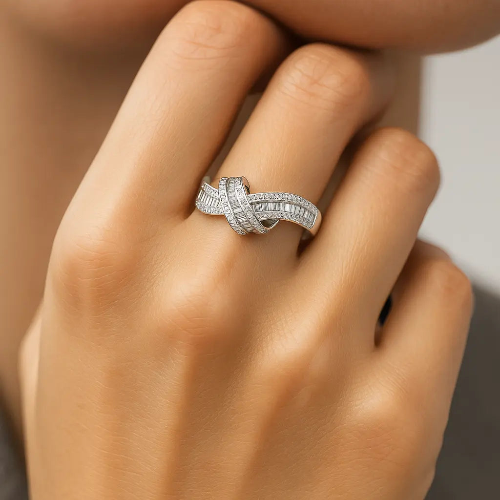 Silver ring with diamonds on a hand against a neutral background