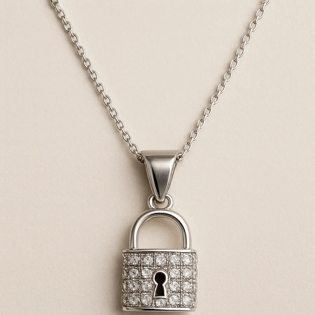 Silver padlock-shaped pendant with diamonds on a beige background
