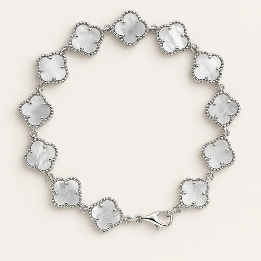 Silver bracelet with clear gemstones on a white background