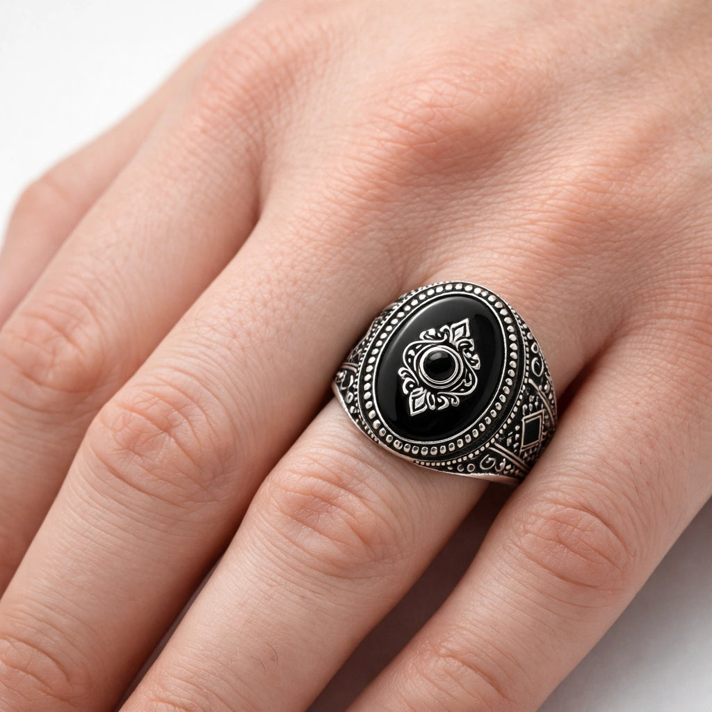 Men’s 925 sterling silver oval ring with glossy black stone and raised crest emblem