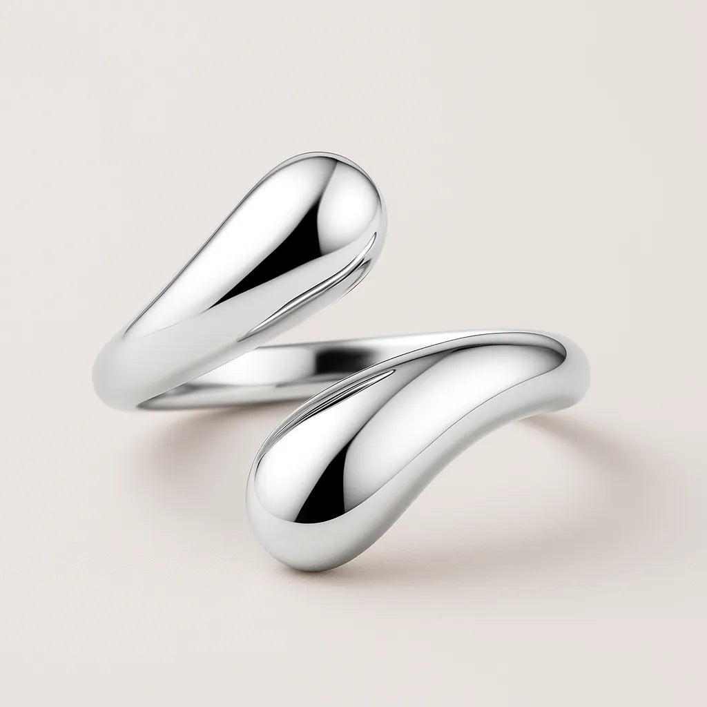Two silver rings on a light beige background