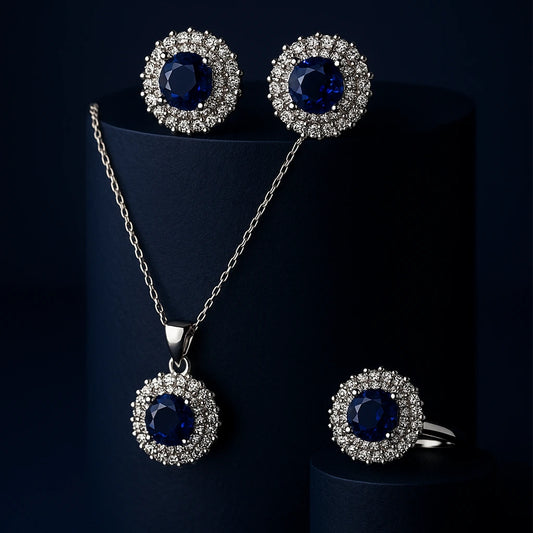 Women's 925 silver sapphire blue Zircon jewelry set from UAE brand. Includes a ring, stud earrings, and necklace pendant, all featuring a central oval blue stone with a white Zircon halo.