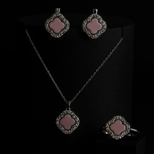 Women's 925 silver jewelry set from UAE brand. Includes a ring, stud earrings, and necklace pendant, all featuring a pink inlay clover motif framed by a white Zircon border.