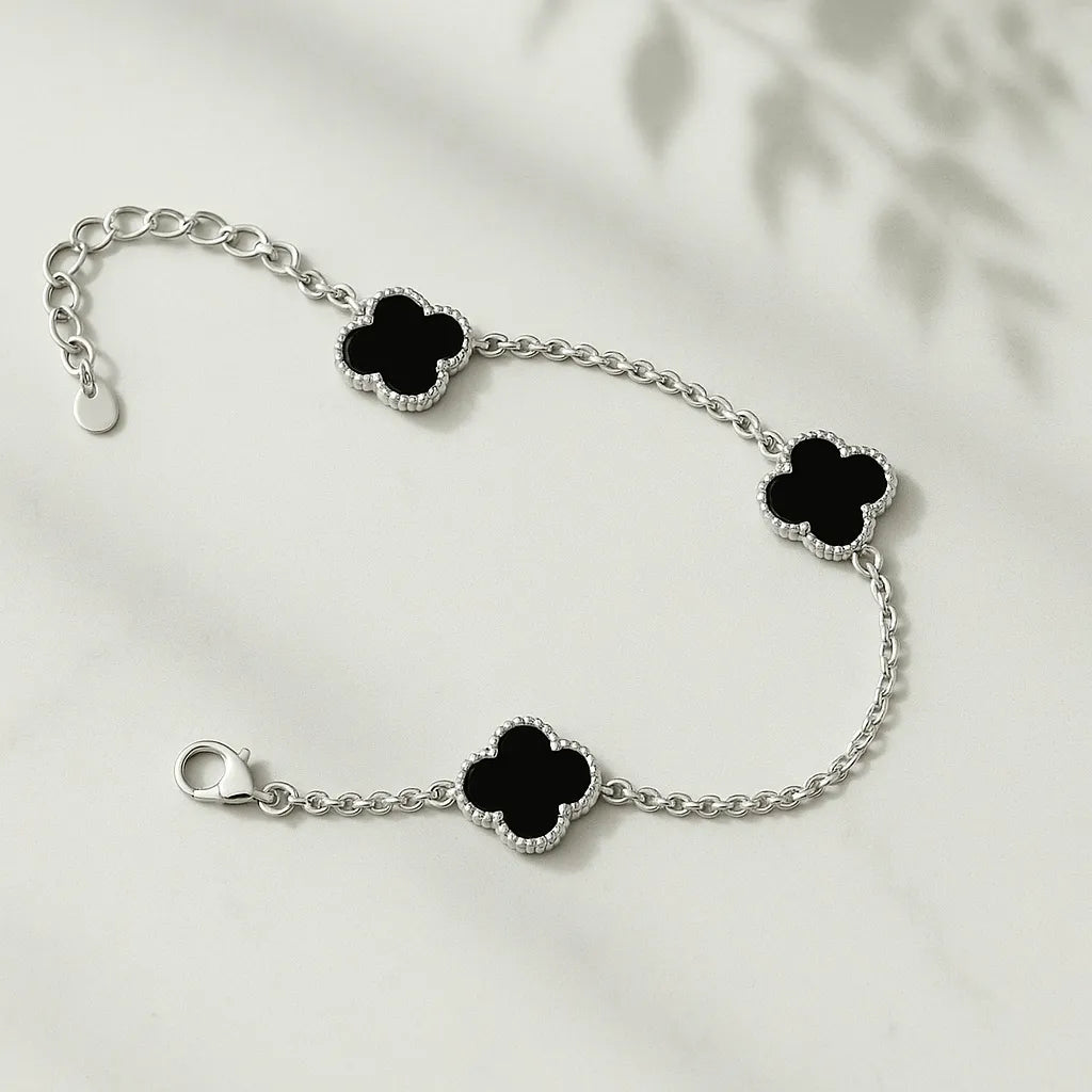 Women's 925 silver adjustable station bracelet from UAE brand. Features three four-leaf clover stations with polished black inlay on a fine chain.
