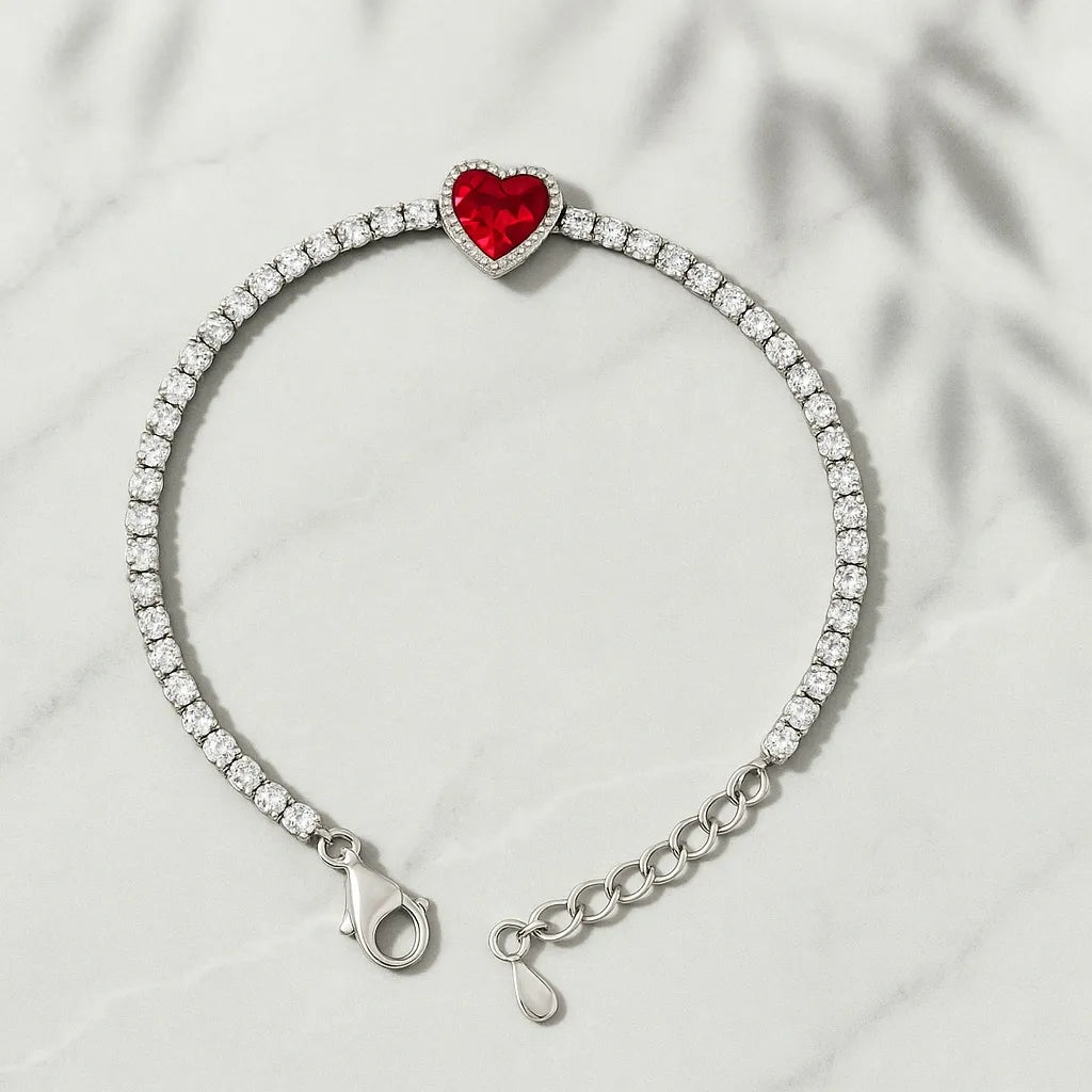 Bracelet with a red heart charm and clear stones on a light gray background
