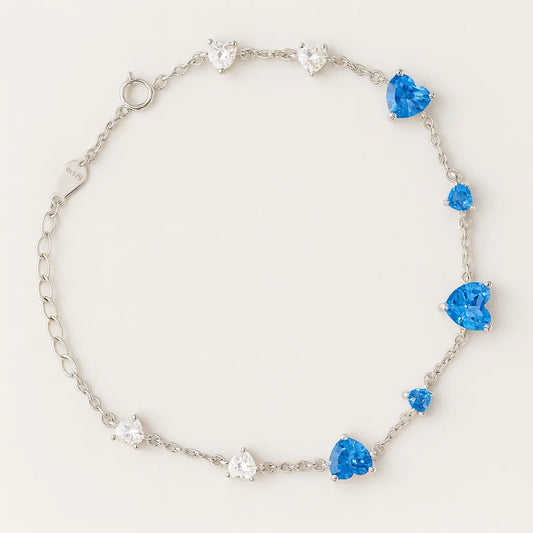 Women's 925 silver adjustable bracelet from UAE brand. Features heart-cut Blue and White Zircon stones scattered along a delicate silver chain.