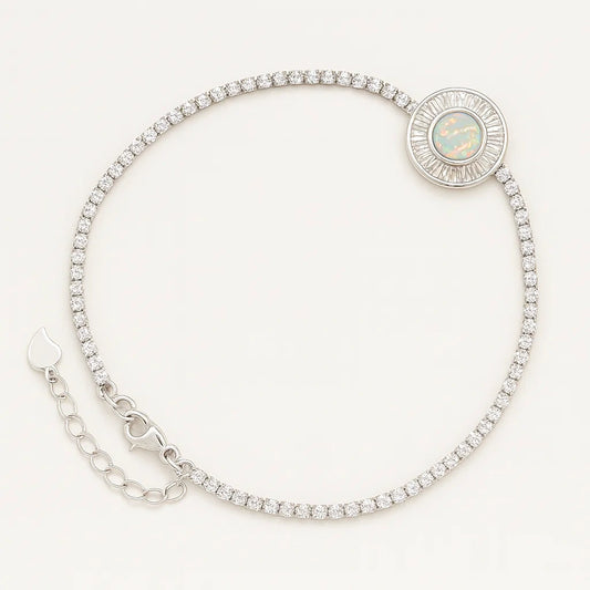 Women's 925 silver adjustable tennis bracelet from UAE brand. Features a continuous Zircon line leading to a circular opalescent center stone with a baguette Zircon halo.
