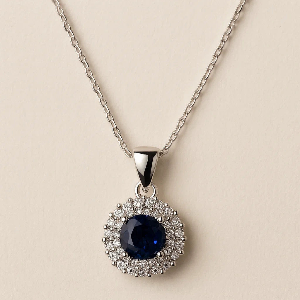 Silver necklace with a blue gemstone pendant on a beige background