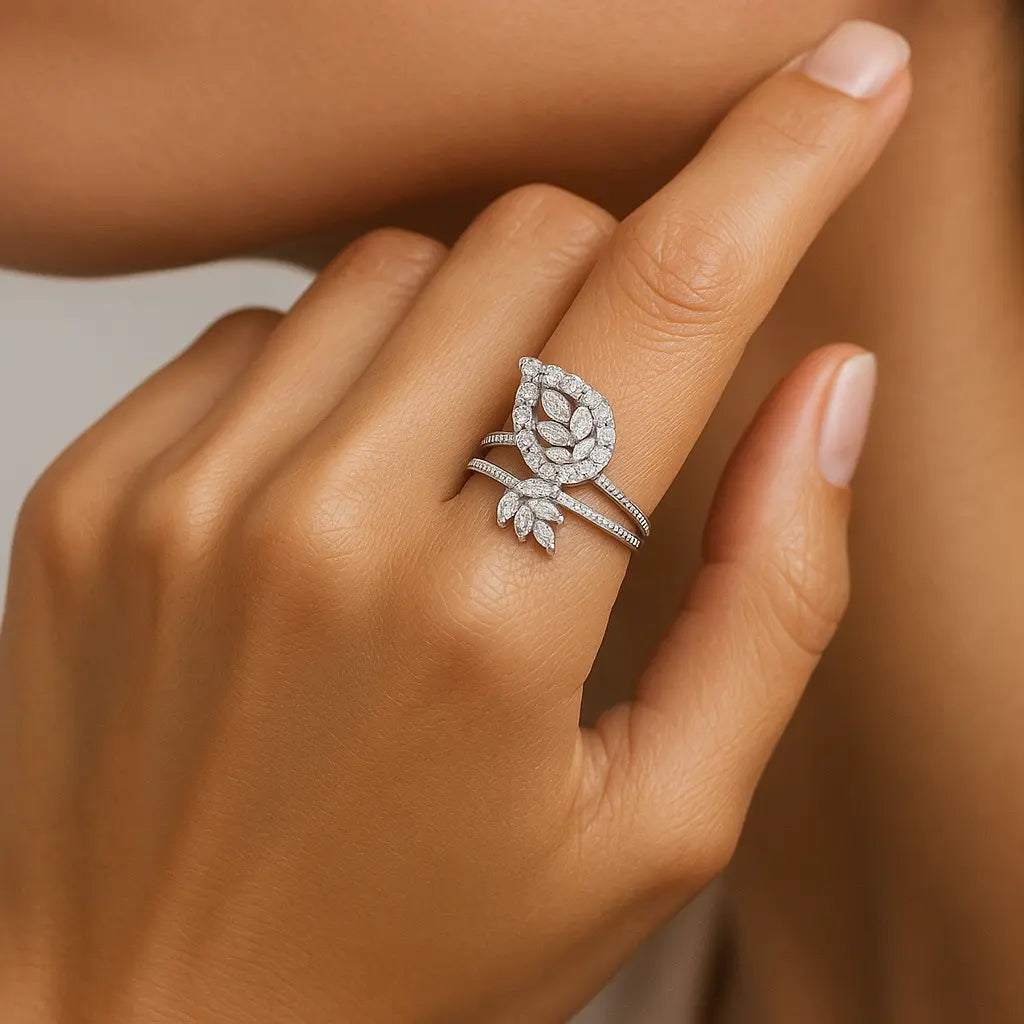 Silver ring with diamond details on a hand against a neutral background