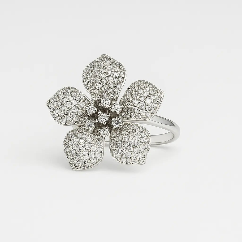 Silver flower-shaped ring with gemstones on a light gray background