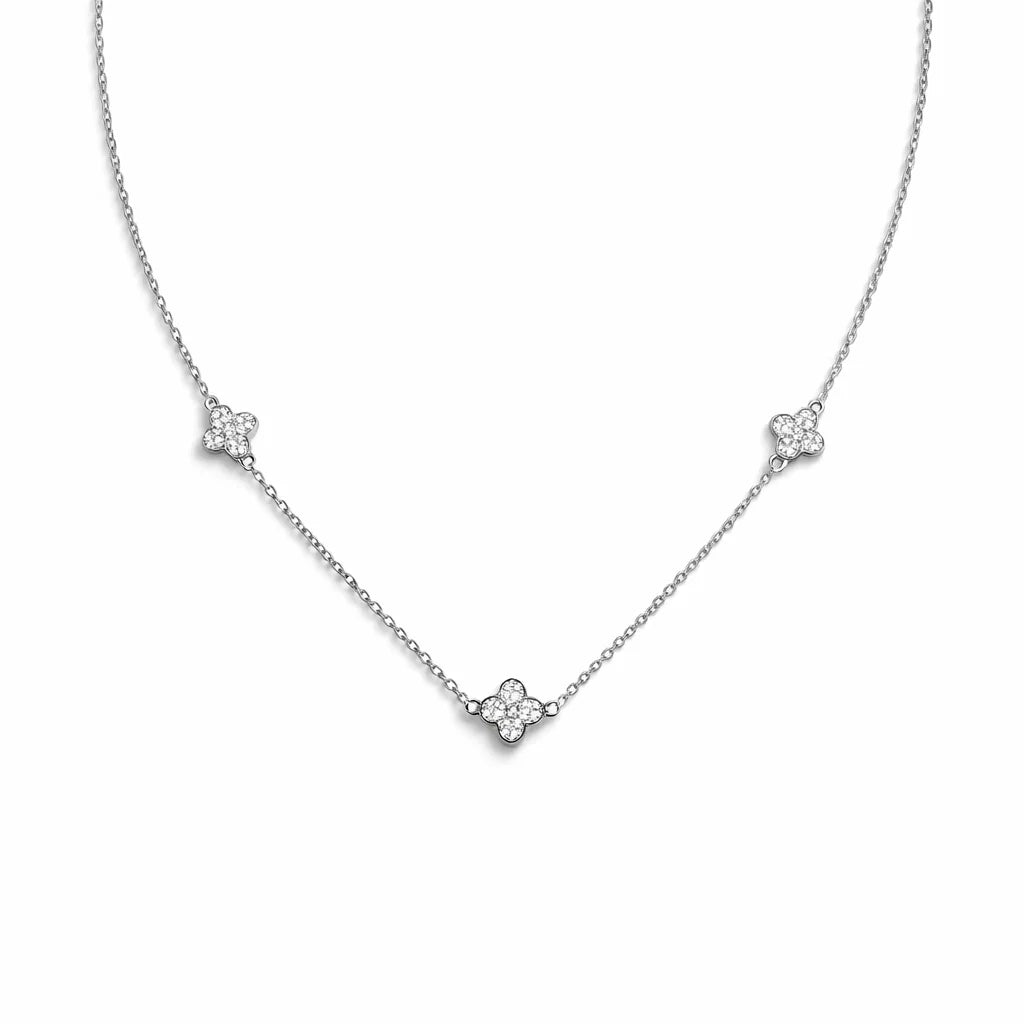 Silver necklace with floral pendants on a white background