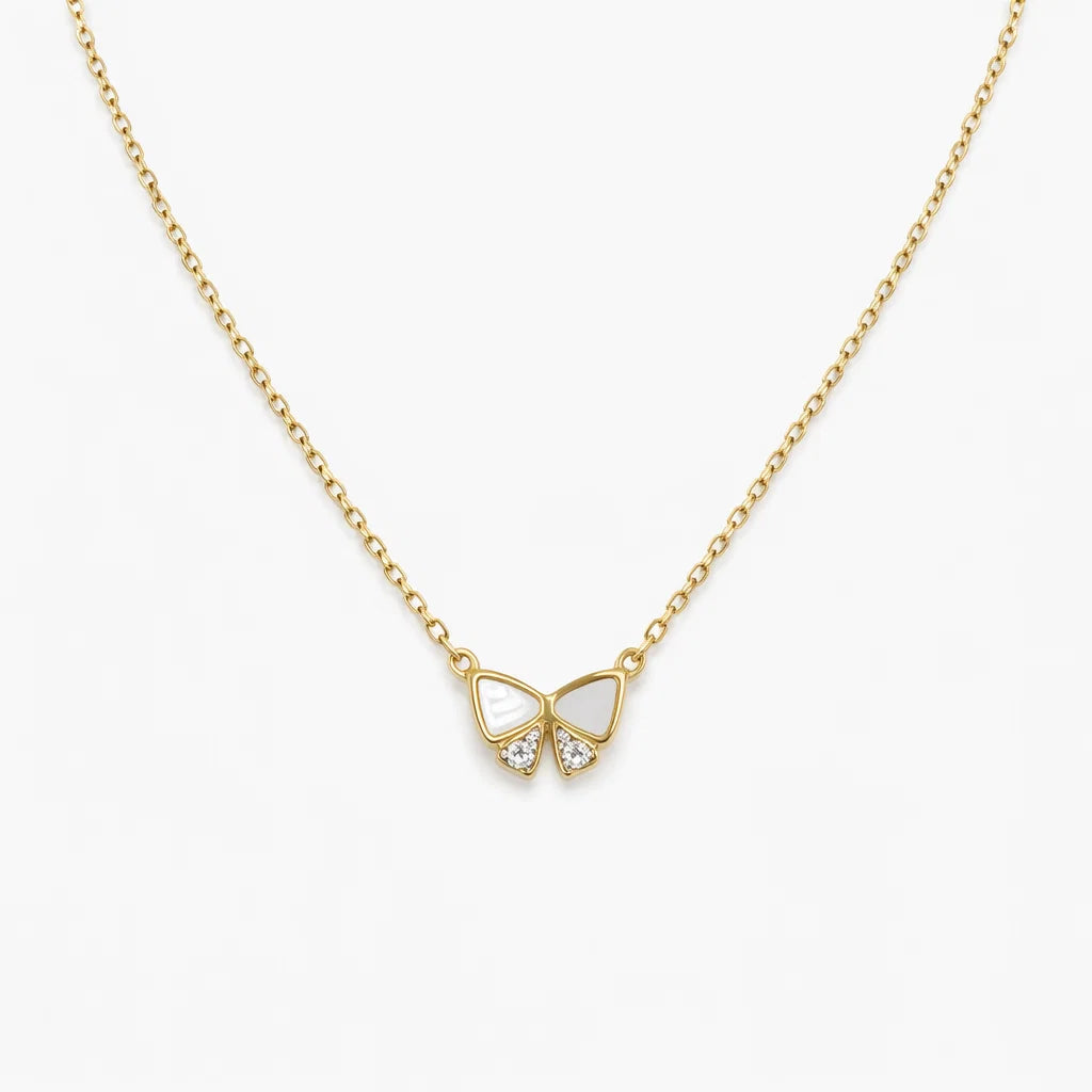 Gold butterfly necklace with heart-shaped center on a white background