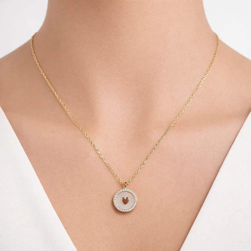 Gold necklace with a heart pendant on a mannequin