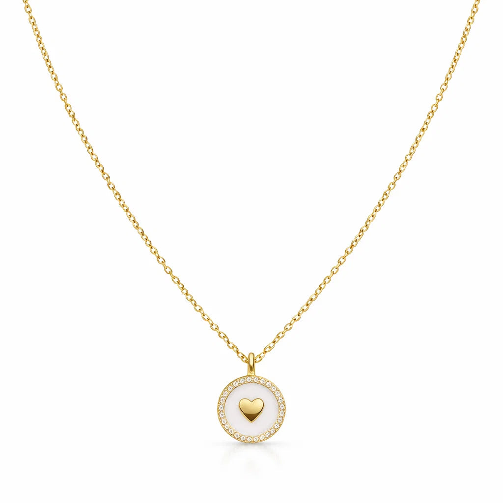 Gold necklace with a heart-shaped pendant on a white background