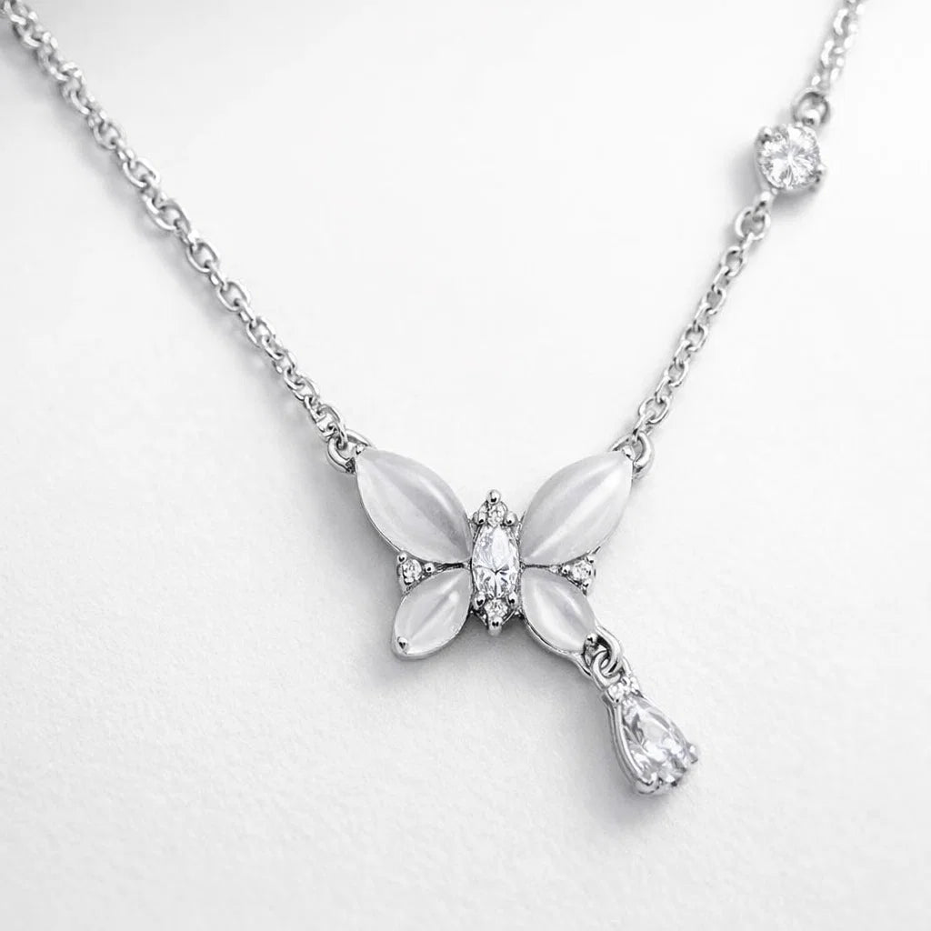 Butterfly-shaped pendant necklace on a light gray background