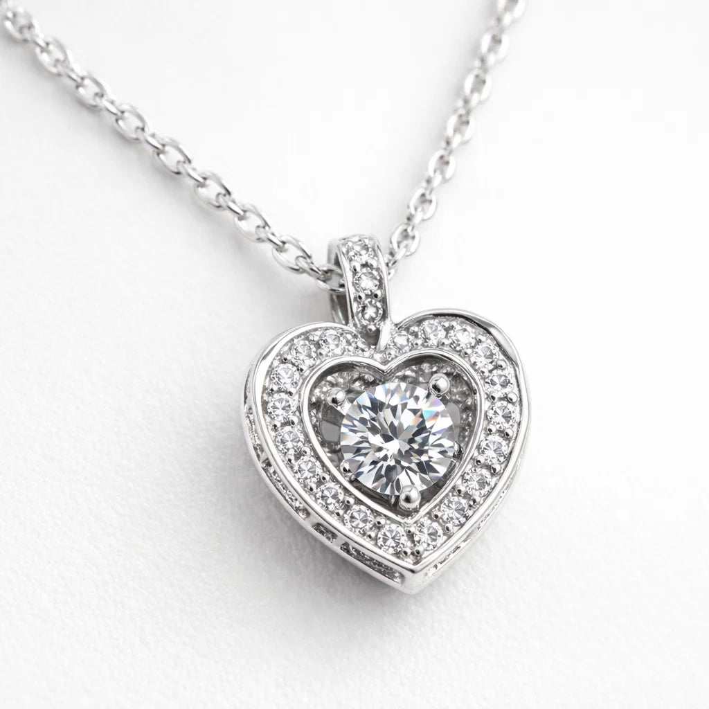 Heart-shaped diamond pendant on a white background