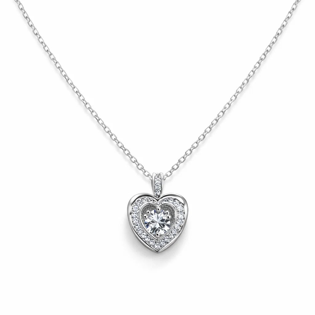 Heart-shaped diamond pendant on a chain against a white background
